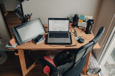 Brown wooden black and silver laptop on the desk
